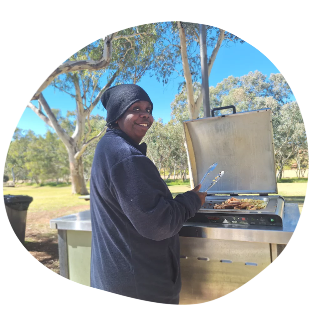 One of our Aboriginal participants spending quality time outdoors cooking on a bbq